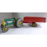 A Mettoy Playthings 'vintage' tinplate clockwork model tractor with front steering and a two