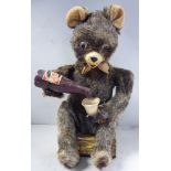 An Alps Japanese made 'vintage' tinplate and fur covered battery powered automaton toy bear,