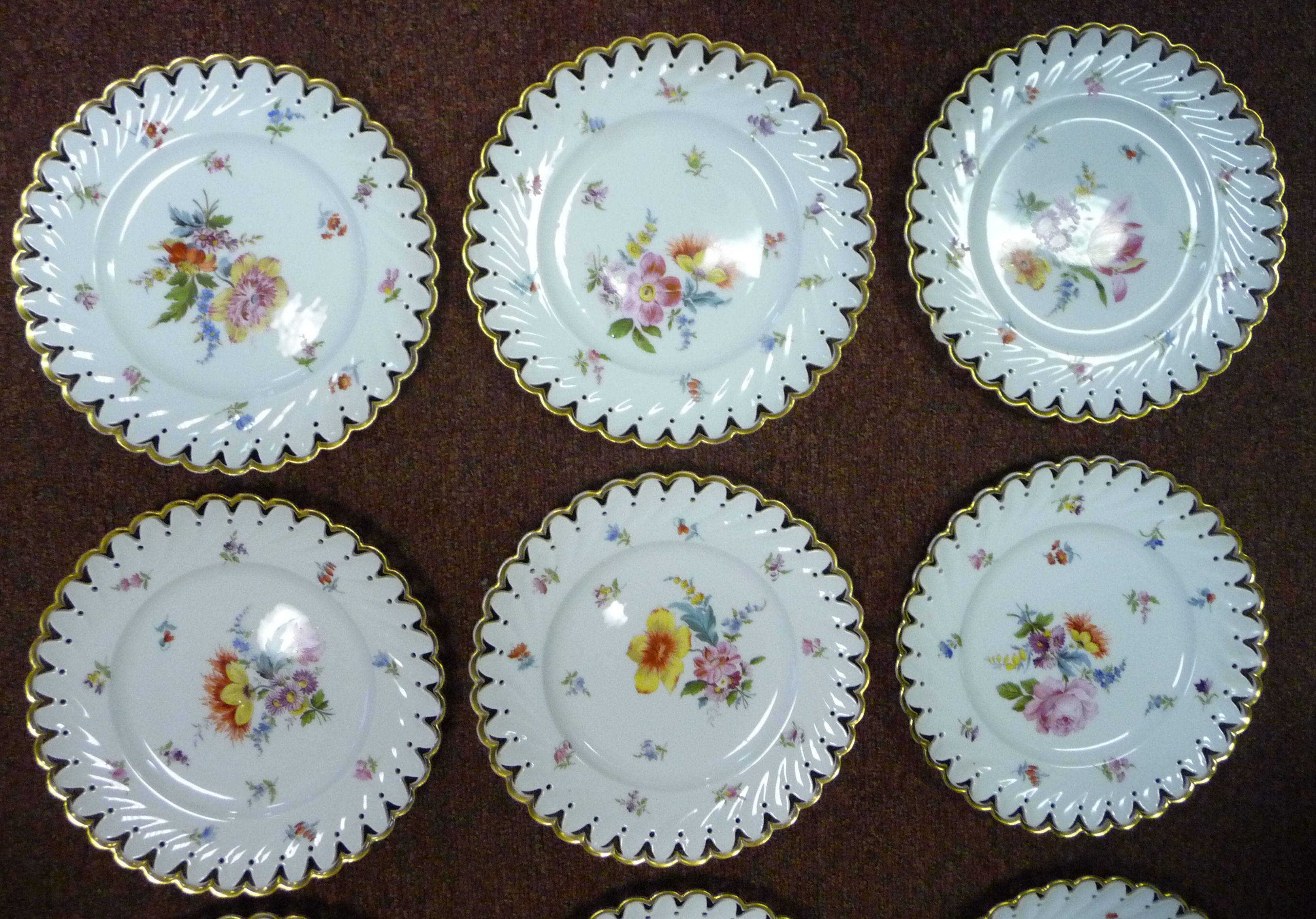 A set of nine early 20thC Continental ivory glazed porcelain dessert plates with thumb moulded, - Image 6 of 11