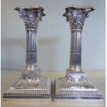 A pair of late Victorian silver candlesticks of square outline, each with a detachable,