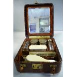 A gentleman's travelling snakeskin covered vanity case with gilded metal fittings,