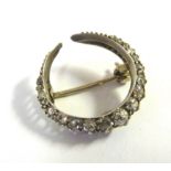 A late Victorian white metal crescent brooch,