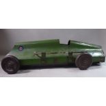 A 1920s scratch built green painted tinplate model racing car with exposed twin exhausts and a