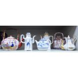 Six various late 19th & 20thC Oriental and European porcelain and china teapots: to include a tall,