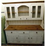 A modern white painted and waxed pine dresser, the superstructure with an arched, open,