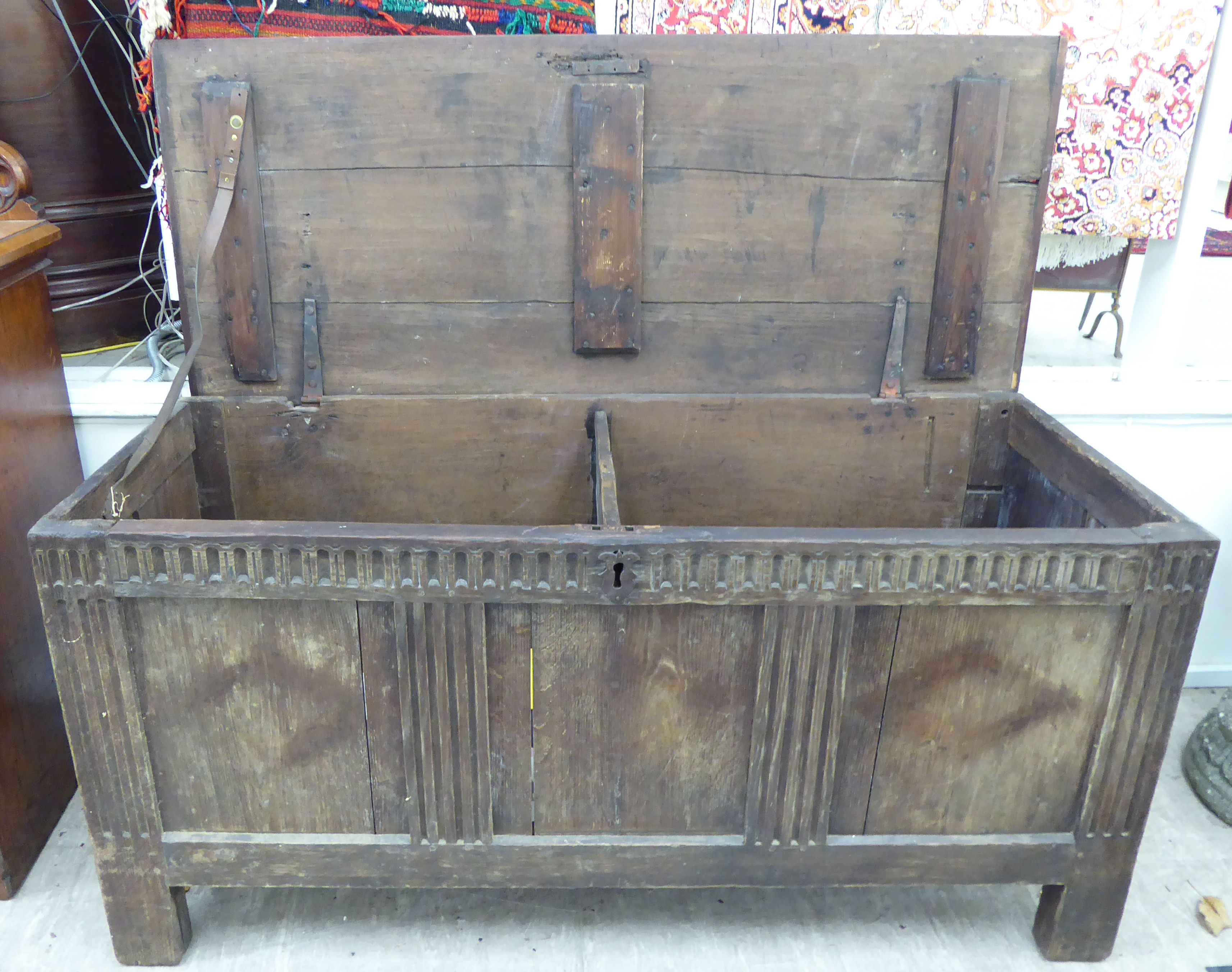 An early 18thC stained pine coffer with straight sides a hinged lid, over a panelled front, - Image 3 of 3