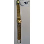 A lady's Rotary 9ct gold square cased wristwatch, on a flexible textured strap,