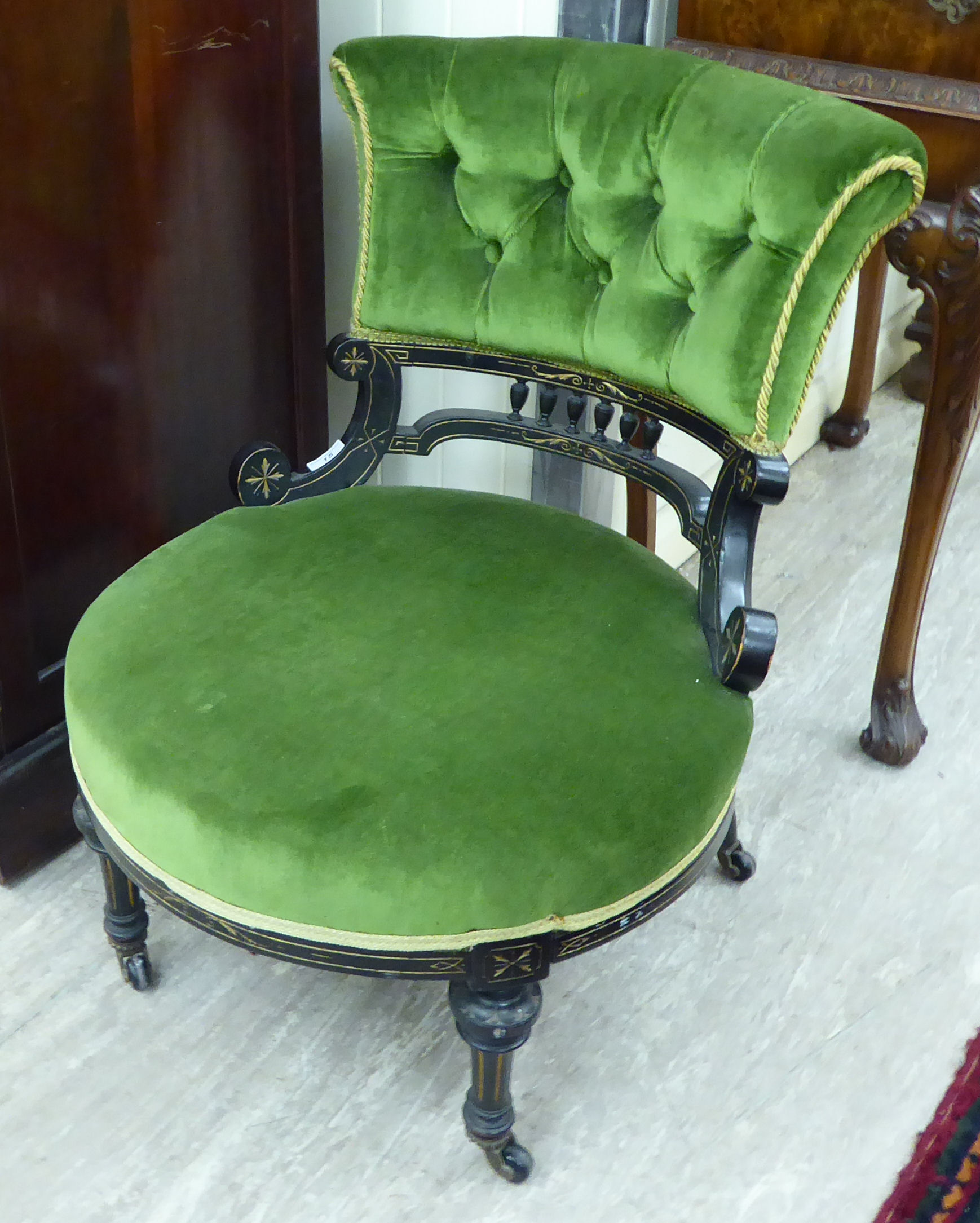 A late Victorian ebonised and gilded, part-button upholstered green dralon,