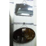 A 1930s oval bevelled mirror,