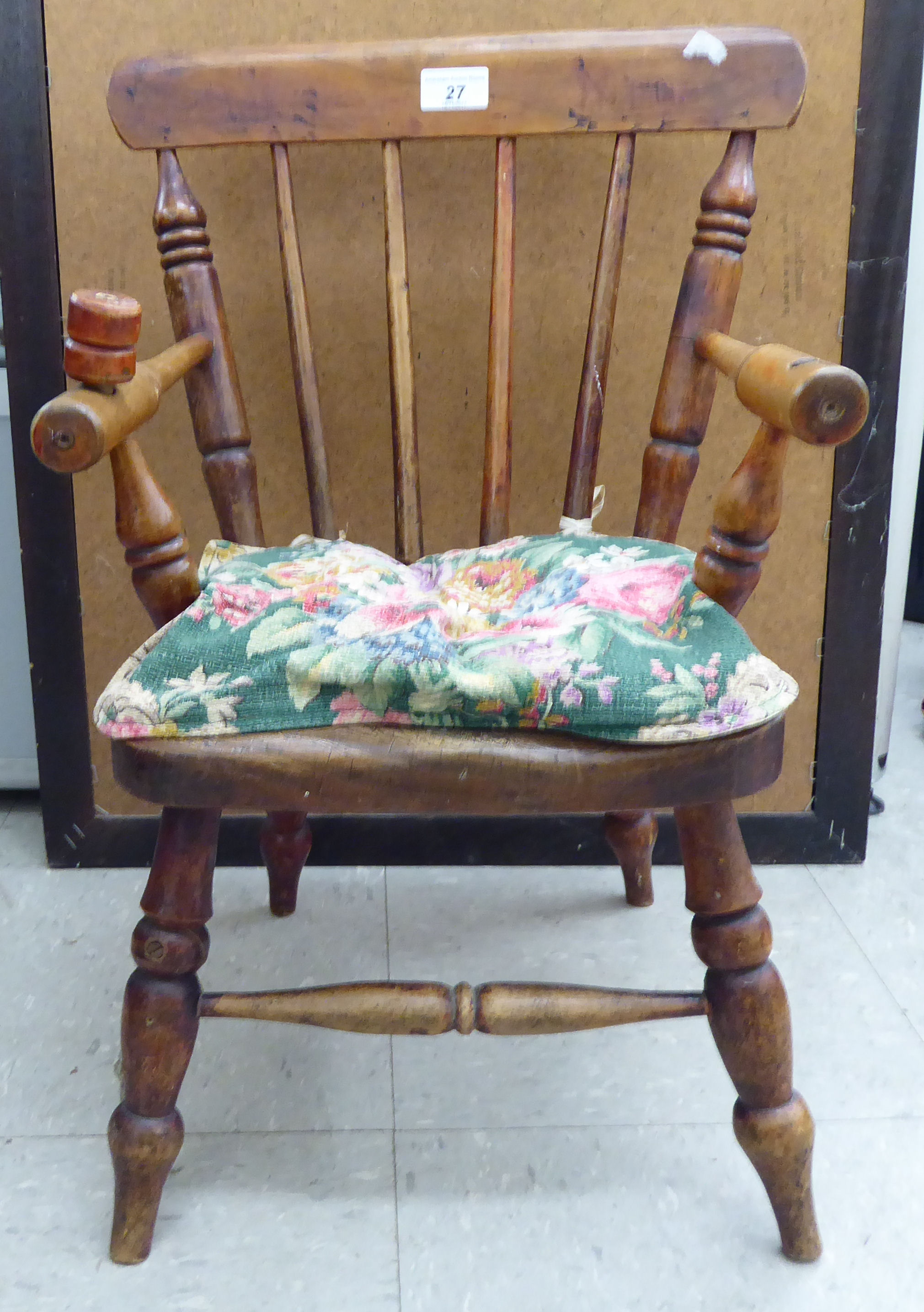 A child's late 19thC beech and elm framed commode chair with a spindle back,