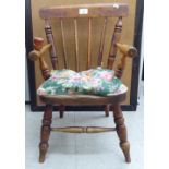 A child's late 19thC beech and elm framed commode chair with a spindle back,