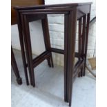 A nesting set of three Edwardian string inlaid and crossbanded mahogany occasional tables,