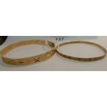 Two similar bright-cut engraved gold coloured metal bangles stamped 14k 11