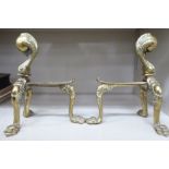 A pair of early 20thC brass fire dogs with a talon and ball finials and cabriole legs 9''h