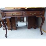 A modern mahogany serving table with two in-line drawers, raised on tapered,