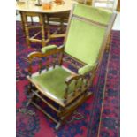 An early 20thC mahogany framed and stud upholstered sage green dralon American rocking chair