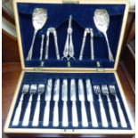 A set of six silver plated knives and forks on mother-of-pearl handles; a pair of berry spoons;