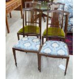 A set of four Edwardian satinwood and ebony inlaid mahogany framed salon chairs,