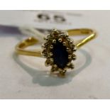 A 9ct gold sapphire and diamond claw set cluster ring 11