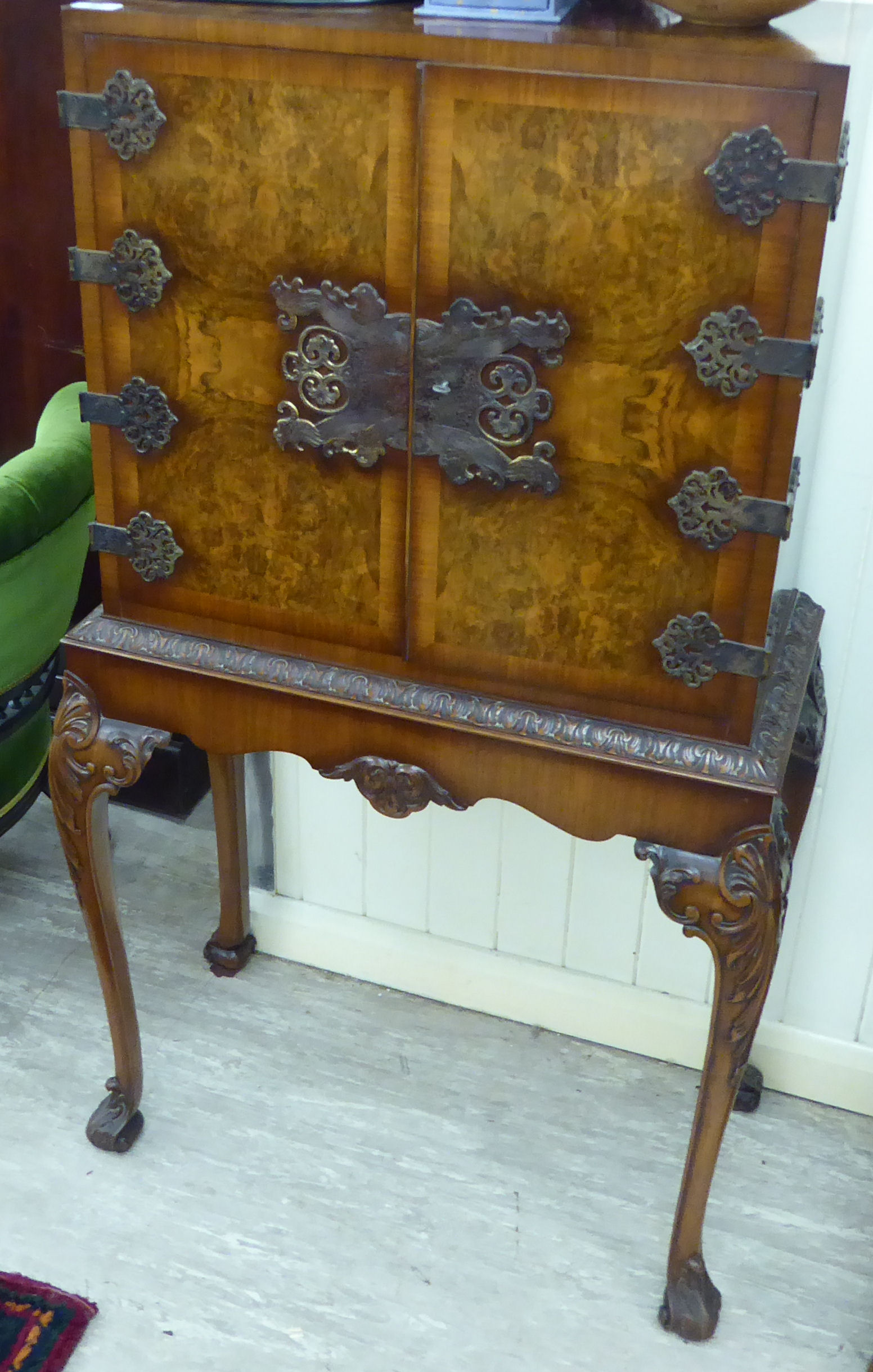 A mid 20thC figured walnut cocktail cabinet,