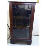 A 1920s crossbanded mahogany display cabinet, the astragal glazed panelled door,