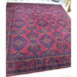 A Persian design rug with repeating floral motifs on a red and blue ground 128'' x 143'' CA