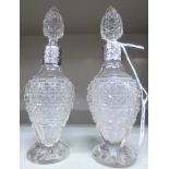 A pair of cut glass scent bottles of waisted,