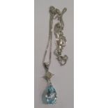 A 9ct gold, white gold, blue topaz and diamond set pendant,