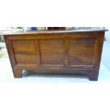 A modern mahogany finished boarded chest with straight sides, a tri-panelled front and a hinged lid,