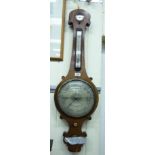 An early/mid 19thC rosewood cased wheel barometer, comprising a thermometer, level and hygrometer,