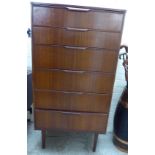 A 1960s Austinsuite, teak finished, six drawer tallboy, raised on square, tapered legs 49''h 25.