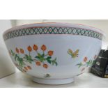 A modern Chinese porcelain bowl, decorated with insects, flora,