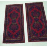 A pair of Indian wool rugs, decorated in blue, green and orange,