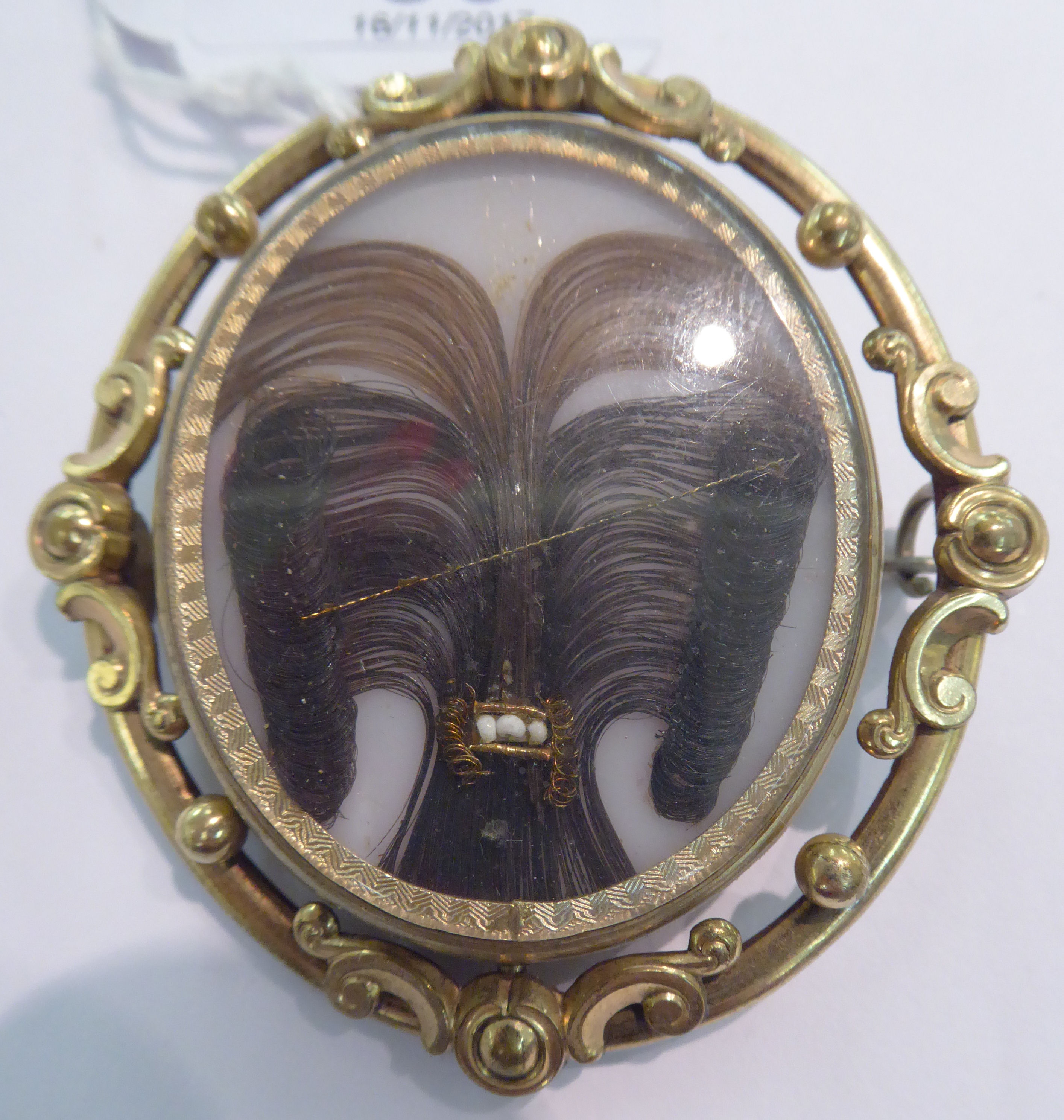 A Victorian yellow metal oval framed rotating mourning brooch 11