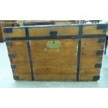 An early 20thC stained pine naval chest with straight sides and a hinged lid,