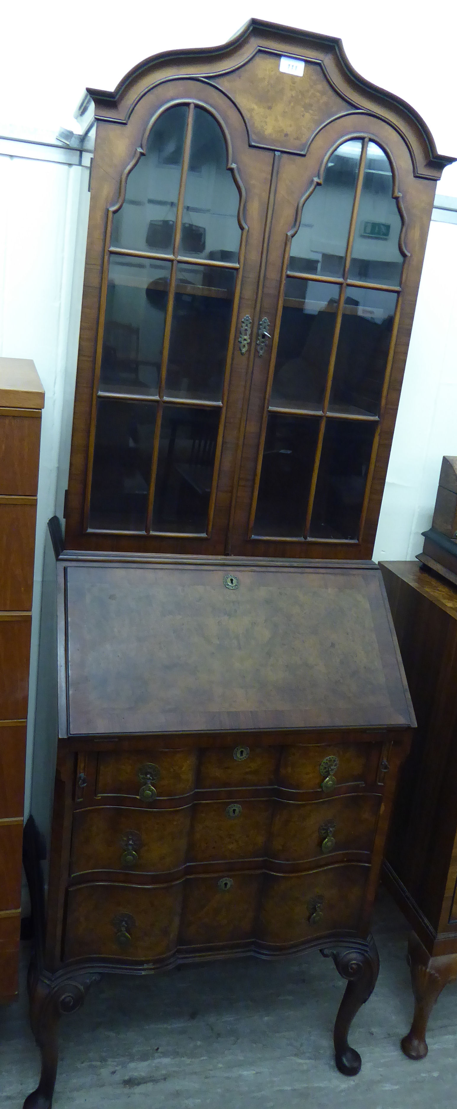 A mid 20thC Queen Anne style walnut bureau bookcase,