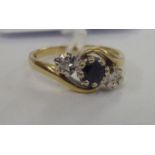 A 9ct gold diamond and sapphire set crossover ring 11