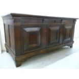 A late 19thC oak chest with a hinged lid, straight sides, a panelled front and a hinged lid,