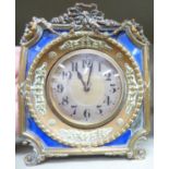 An early 20thC decoratively cast brass and engine turned blue enamel backed traveller's timepiece;