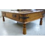 A modern Indonesian hardwood coffee table, over two frieze drawers with applied iron mounts,