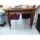 A late Victorian walnut wind-out dining table, the top with canted corners, raised on turned,