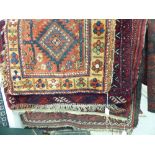 Rugs: to include a Persian runner with stylised designs on a red ground 30'' x 56'' SL