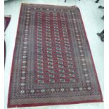 A Turkoman rug with four columns of twenty-two guls on a red ground 64'' x 104'' S