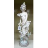 A Lladro porcelain figure, a scantily clad woman,
