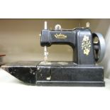 A mid 20thC Vulcan black painted and gilded manual sewing machine OS3