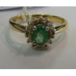 A 9ct gold claw set emerald and diamond cluster ring 11