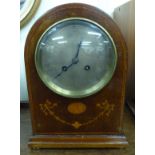An Edwardian mahogany marquetry cased mantel clock with a round arched top,