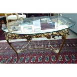 A modern glass topped coffee table, raised on a gilded rose and foliate cast underframe 16.