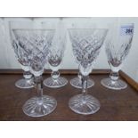 A set of four Waterford crystal pedestal wine glasses with line-cut ornament and two similar