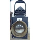 An early 20thC black painted steel railway lantern with a crinoline chimney vent 16''h LAB